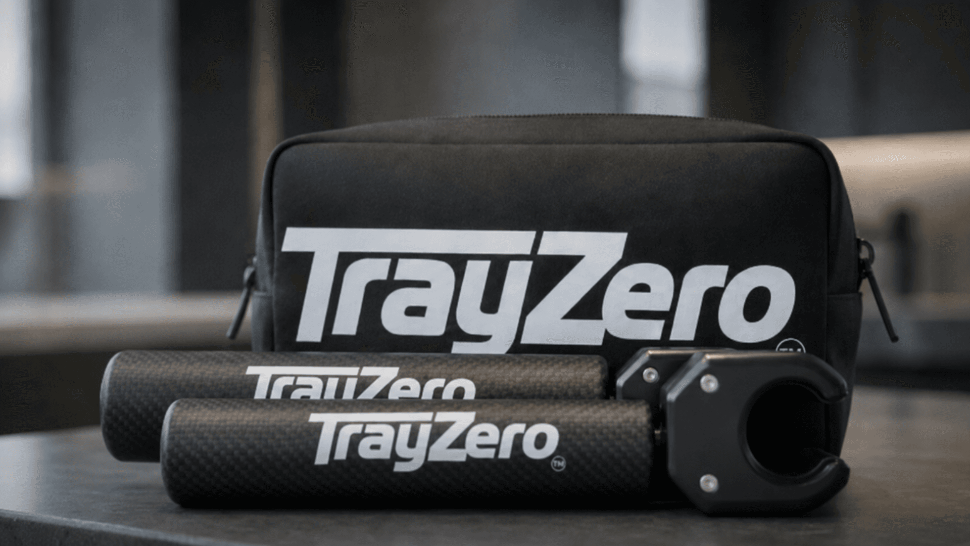 TrayZero storage pouch with two parallel support arms and clamps