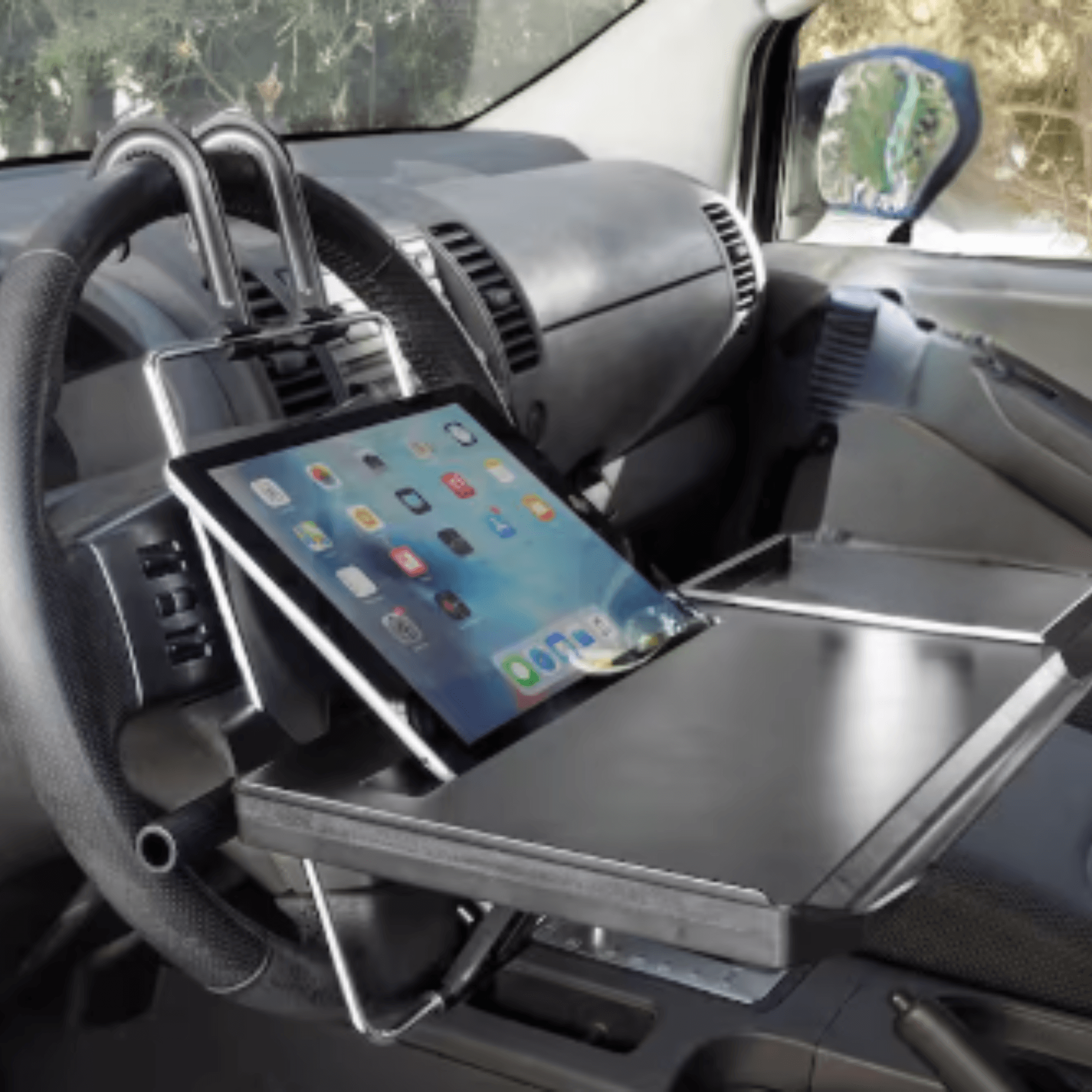 Traditional bulky steering-wheel tray setup representing the old way of working in a vehicle